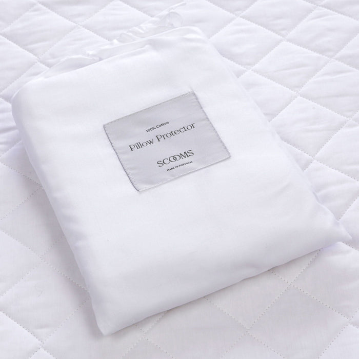 White cotton pillow protector bag containing two jersey cotton pillow protectors | Scooms