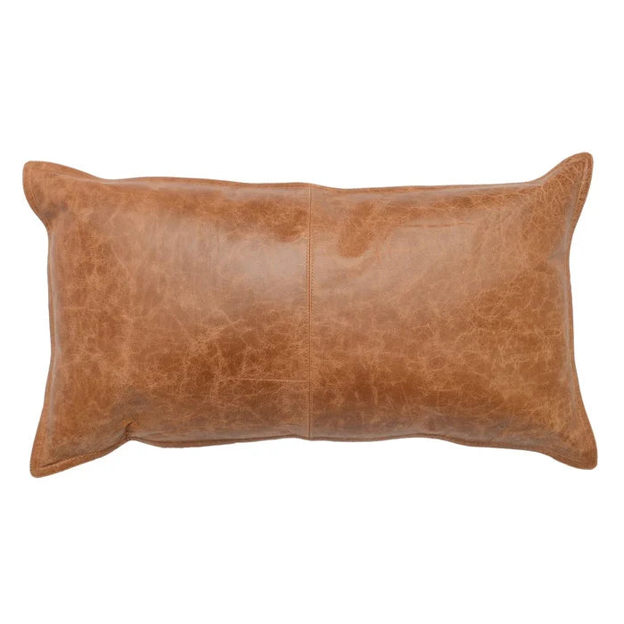 The 14x26 Leather Pillow features brown genuine leather with visible stitching, a smooth textured surface, and a feather blend insert for comfort, shown against a white background.