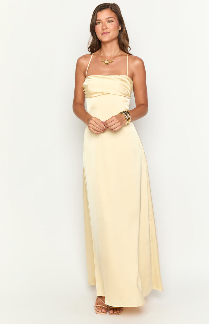 Front view of a yellow satin maxi dress with a draped straight neckline and thin spaghetti straps