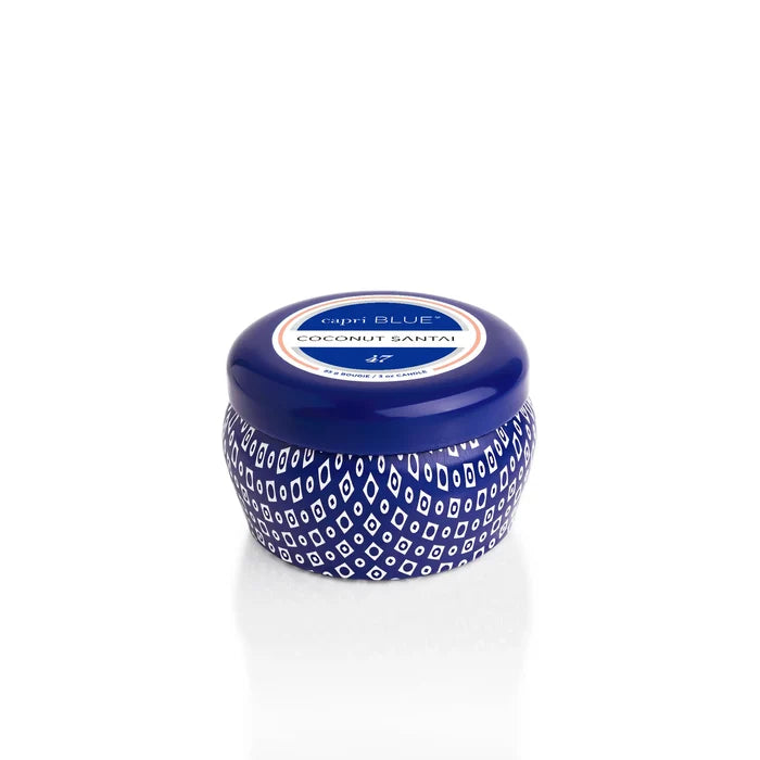 A Capri Blue Mini Tin candle in a small blue jar with a white patterned design and round lid, labeled Coconut Santal and reminiscent of the Volcano scent, is displayed on a white background.