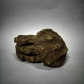 This is an image of Desi Mosquito Repellent Cow Dung Cake kept against grey color background.