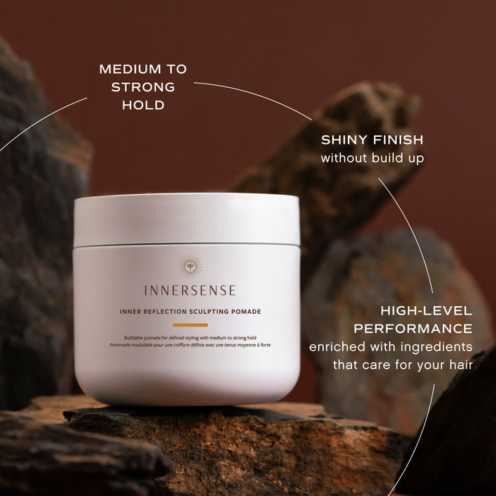 Innersense pomade jar with product features on a wooden background