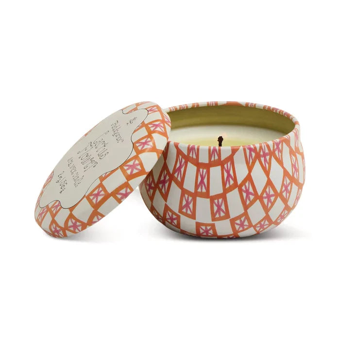 The Printed Tulip Candle Tin features a peach and white geometric design in a round tin with matching lid beside it. The unused candle has a centered wick and is ready to fill your space with the Bronzed Gardenia fragrance.