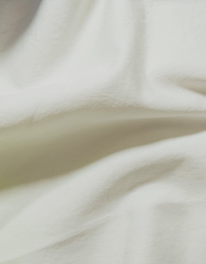 Greige Sei Cotton Sateen Sham - Close-Up Draped Fabric, Warm Off-White Sateen Weave Detail | MATTEO