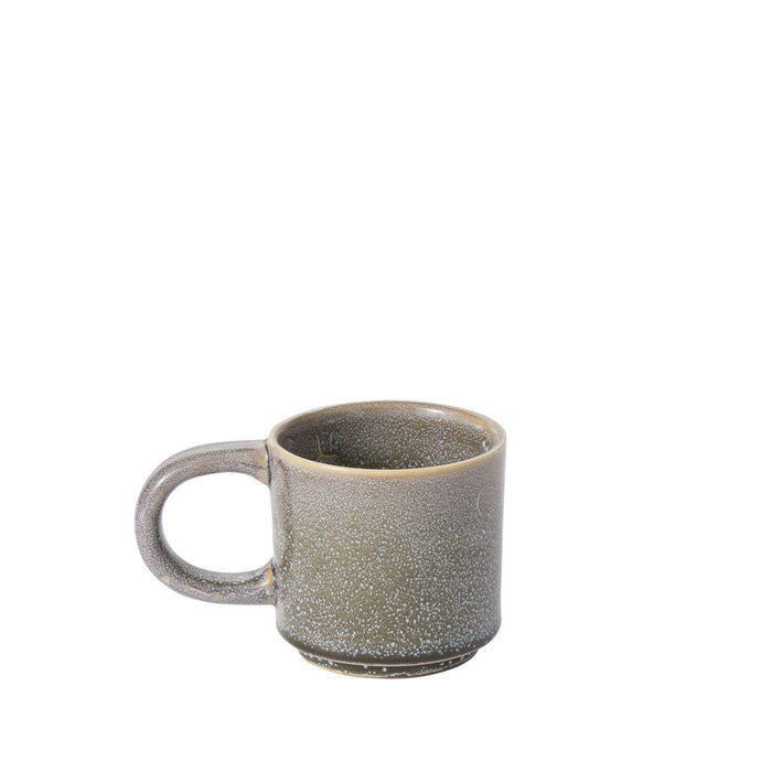 The Starling Mug Collection features a ceramic coffee mug with a large handle, speckled grayish-green reactive glaze, and a slightly darker base, highlighting artisanal tableware against a plain white background.