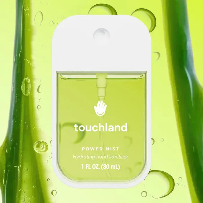 A bottle of Touchland Hand Sanitizer Mist with light green liquid appears amid aloe vera and droplets. The labeled 1 fl oz (30 mL) bottle notes a delicately scented, hydrating formula for your hands.
