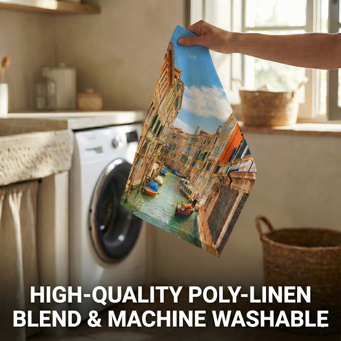 Person holding a folded piece of fabric with a scenic design in a kitchen.