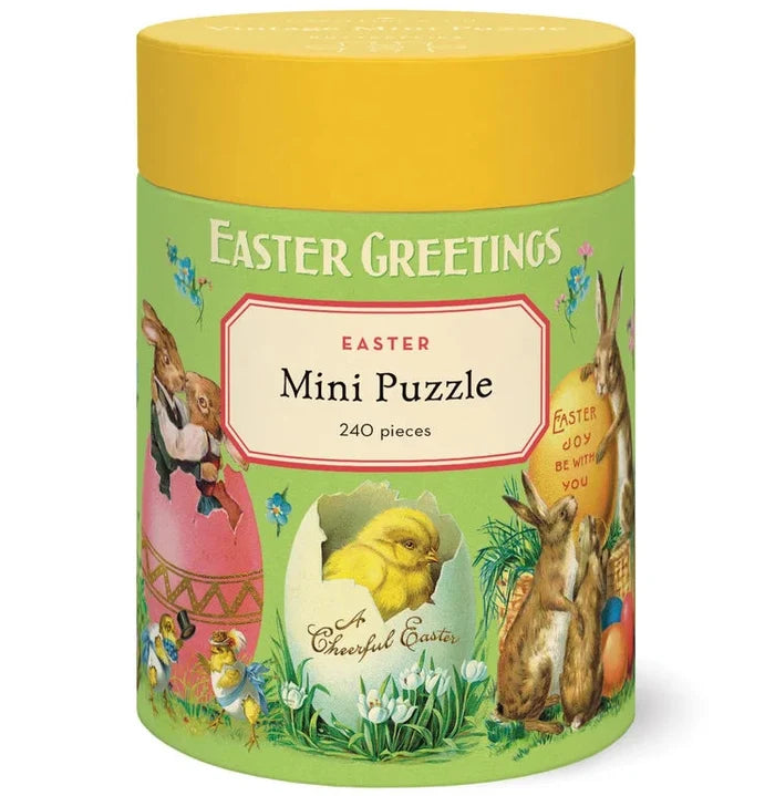 The Vintage 240 Piece Puzzle comes in a cylindrical container with “Easter Greetings” and “Mini Puzzle,” decorated with vintage rabbits, chicks, eggs, flowers, and spring scenes on green with a yellow lid—a delightful gift.
